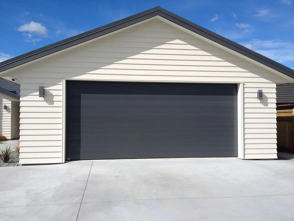 Why Black Garage Doors on a White House Are Trending