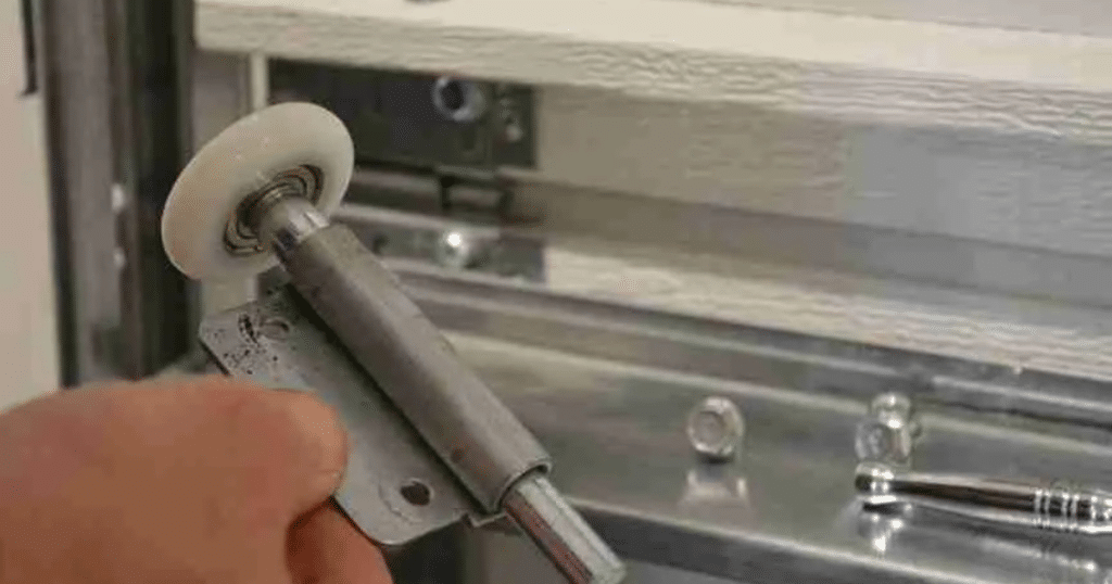 how to get a garage door wheel back on track